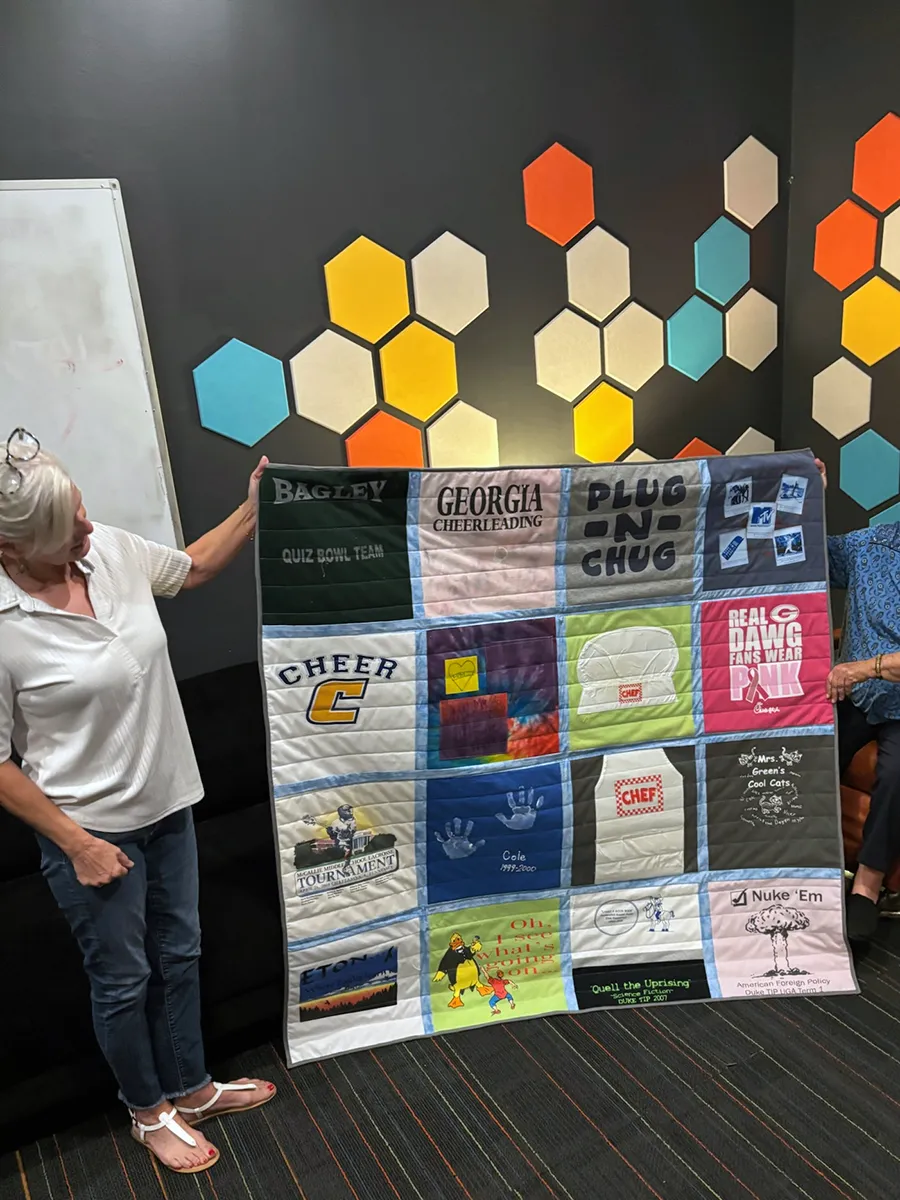 Second side of the double-sided t-shirt quilt showing the remaining shirts from the collection, equally full and colorful