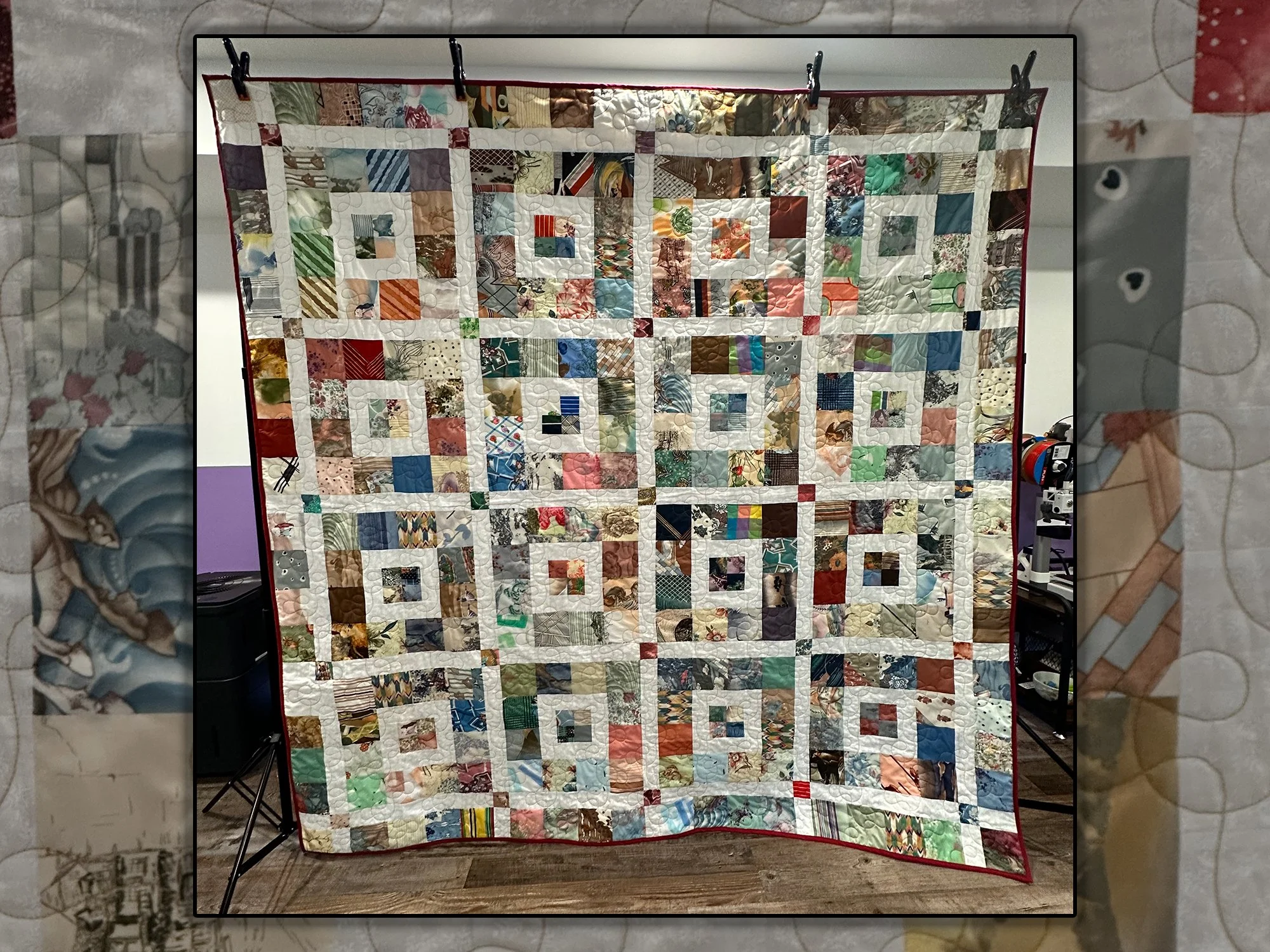 Beautiful custom queen-size quilt made from luxurious lingerie fabric scraps in Atlanta studio, featuring white negative space design