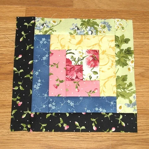 A view of a Log Cabin quilt block showing the light and dark contrast.