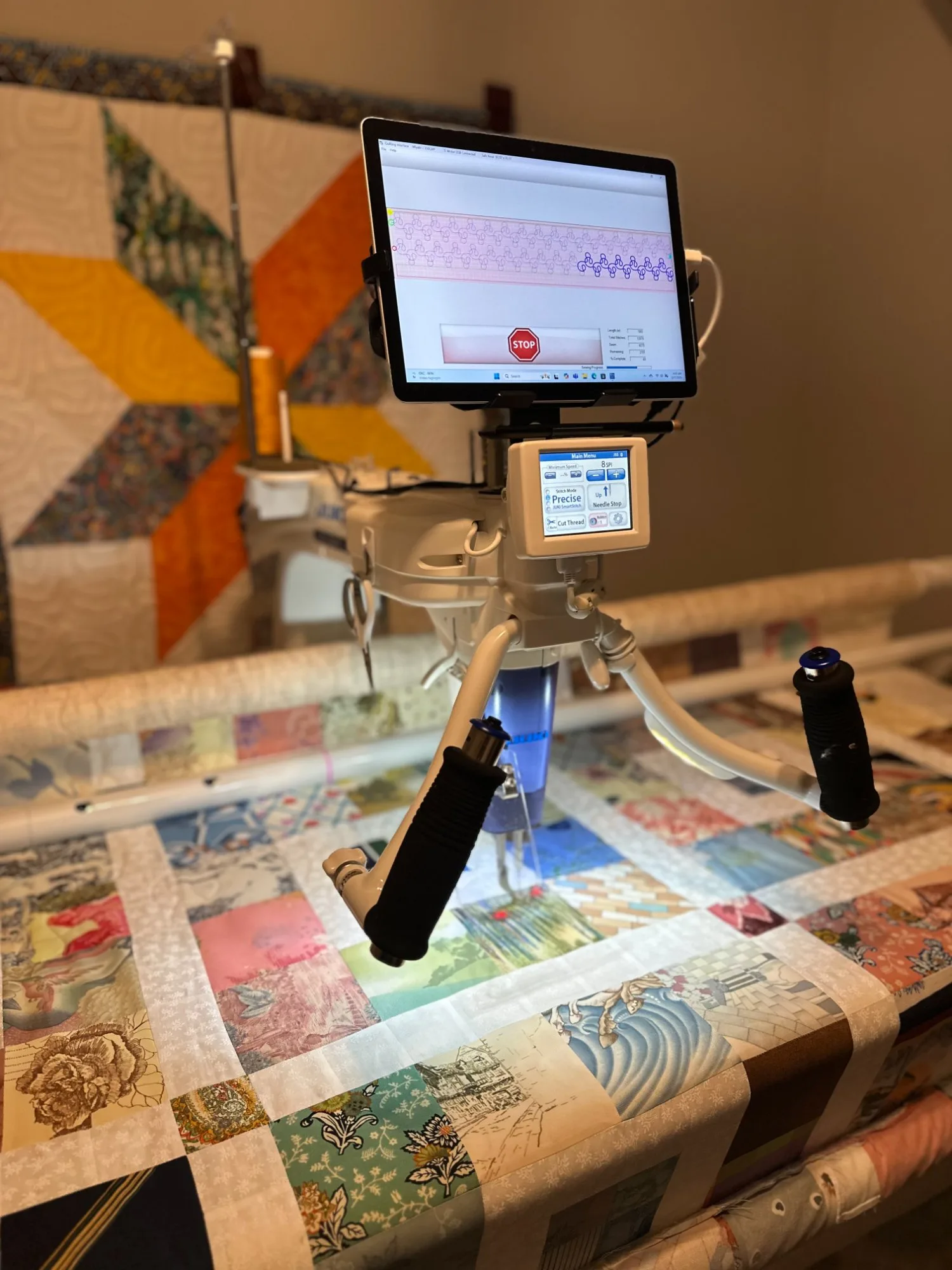 Long arm quilting machine finishing a fairytale and storybook themed quilt with a decorative border stitch pattern