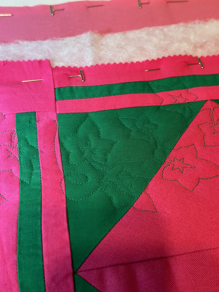 Finished edge-to-edge quilting pattern on a colorful patchwork quilt top showing consistent stitch density across the full width