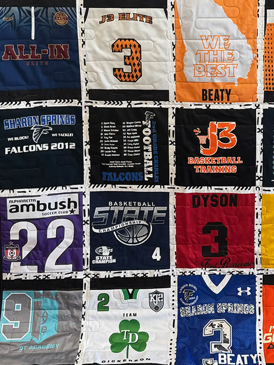 Close-up of appliqued name and number detail on a basketball jersey block in the finished sports jersey quilt