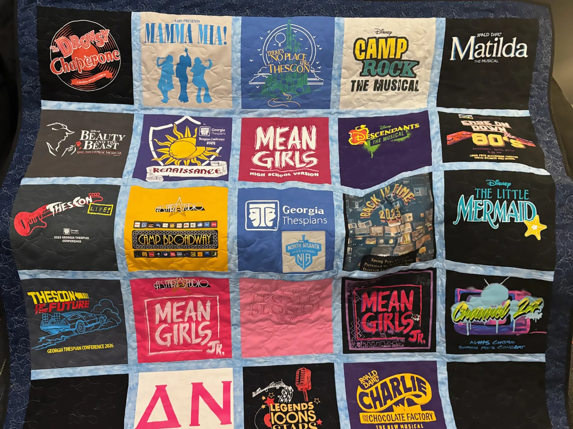 High school theater t-shirt memory quilt with star border fabric and star stitch quilting, made by Wesley Hall in Atlanta, GA