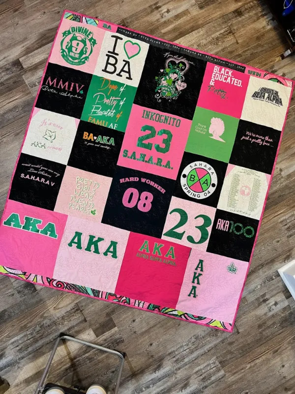 Alpha Kappa Alpha sorority t-shirt quilt in pink, green, and black featuring chapter shirts and Greek paraphernalia, made by Quilts by Big Wes in Atlanta