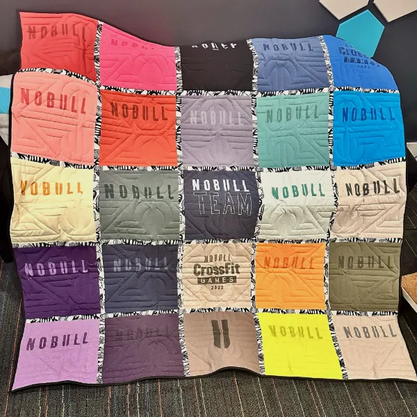 NoBull CrossFit t-shirt quilt featuring a full rainbow of NoBull athletic shirts and CrossFit Games event shirts, handmade by Quilts by Big Wes