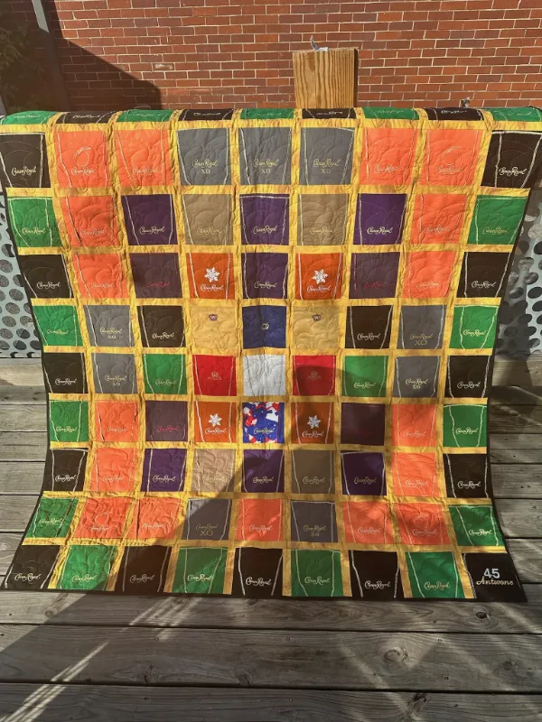 Crown Royal quilt made entirely from whiskey bag fabric in purple, orange, green, and gold, handmade in Atlanta by Quilts by Big Wes
