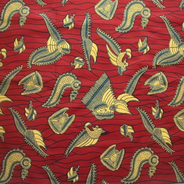 Crevettes. A red fabric with gold and blue designs.